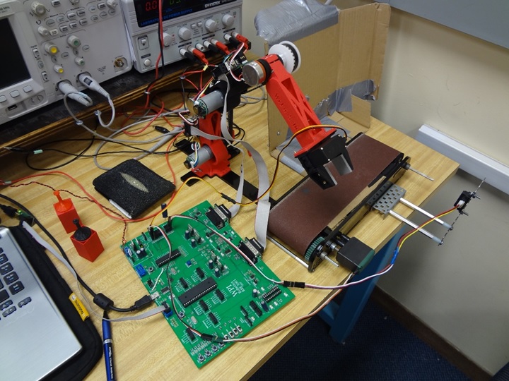 The electronics board, robot arm, and conveyor system.