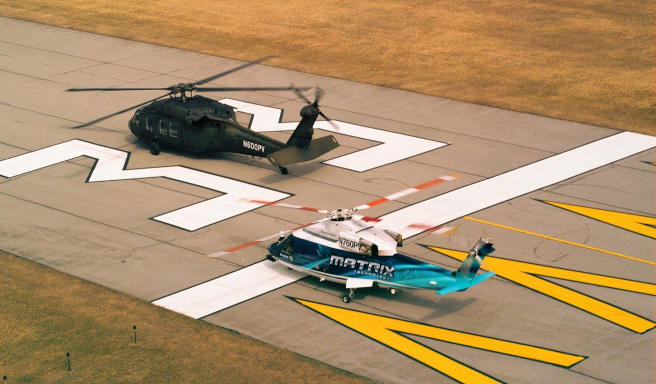 A Black Hawk and SARA taking off from a runway.